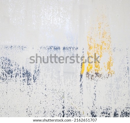 Frosted glass problem or failing. Dissolving privacy fence from age and exposure between two balconies or patio. Abstract grunge texture or surface. Selective focus on semi-transparent frosted glass.