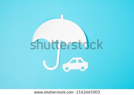 Umbrella cover Car paper on blue background. Warranty, Maintenance, Vehicle and insurance concept