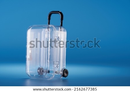 transparent  luggage and blue background                        