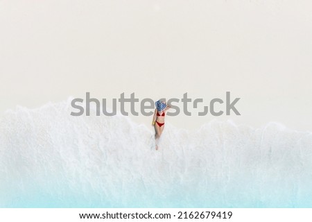 Happy relax time with woman body in bikini sunbathing as laying on the  beach, blue sea water in background -Summer fashion concept,top view