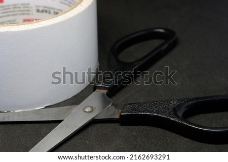 a black scissors on a black background