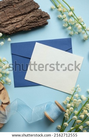 card mockup with with lily of the valley. wooden decor