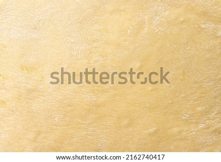 Texture of evenly rolled dough.Background of the dough for baking. High quality photo Royalty-Free Stock Photo #2162740417