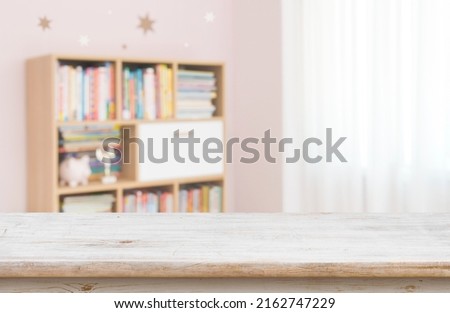 Empty desk for product display on defocused children room background Royalty-Free Stock Photo #2162747229