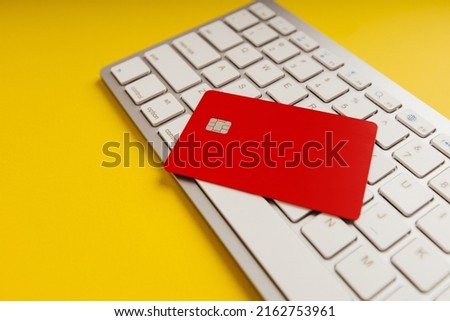Credit card for shopping online, standing on a computer keyboard.