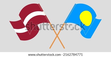 Crossed and waving flags of Latvia and Palau. Vector illustration
