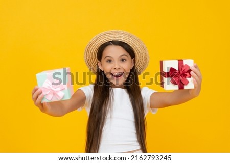 surprised teen girl hold present box on yellow background