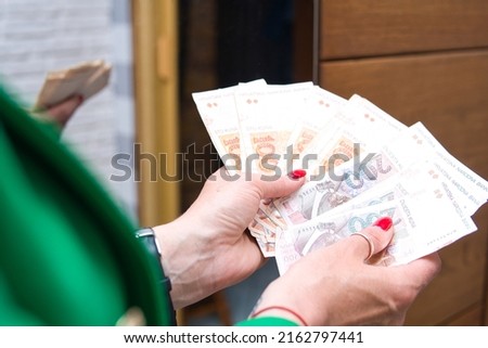 the woman holds Croatian Kuna (Hrvatska kuna) in her hands. Concept showing Croatian economy, business and finance Royalty-Free Stock Photo #2162797441