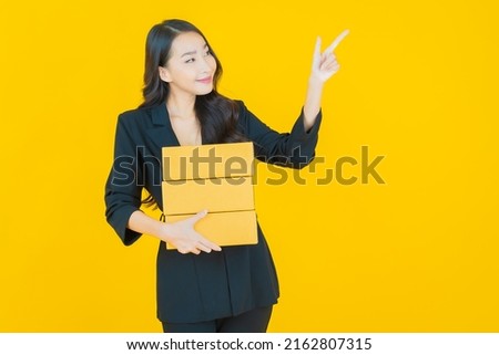 Portrait beautiful young asian woman with box ready for shipping on color background
