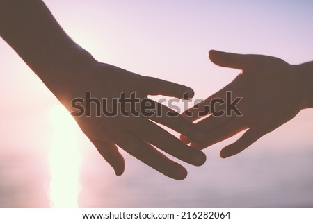 Senior couple hands reach silhouette Royalty-Free Stock Photo #216282064