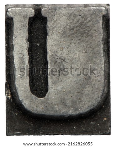close up macro metal lead letter of printing house for text setting against white background showing capitol U