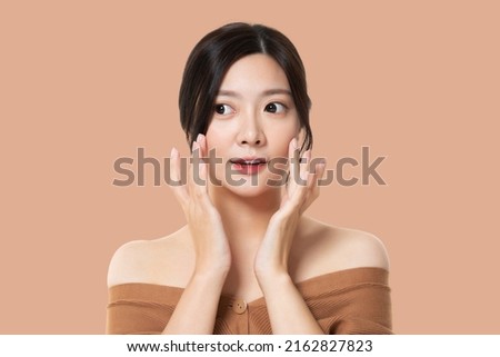 Beautiful Model Girl With Perfect Fresh Clean Skin. Youth And Skin Care Concept. Isolated On Pastel Brown Background.