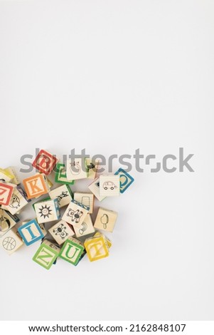 A pile of children painted alphabet wooden blocks isolated with white background for text copy space.