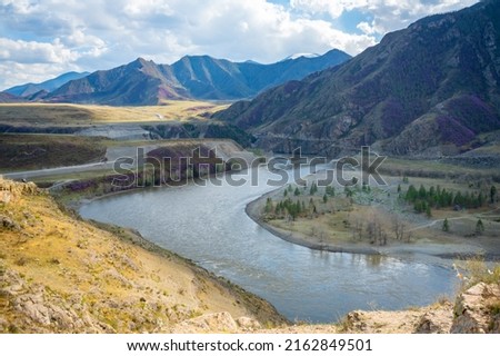 Confluence of Chuya and Katun rivers in Altai mountains, Siberia, Russia. Spring landscape. Famous tourist destination. High quality photo