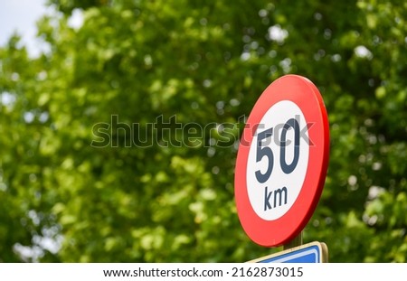 Street traffic sign showing that the maximum speed limit on the road is 50 kilometres per hour kmh. Transportation industry.