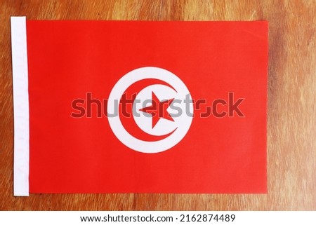 Tunisia flag of silk with copyspace for your text or images and wood background - flags on a painted wood background - Tunisia National Flag on wood grain background