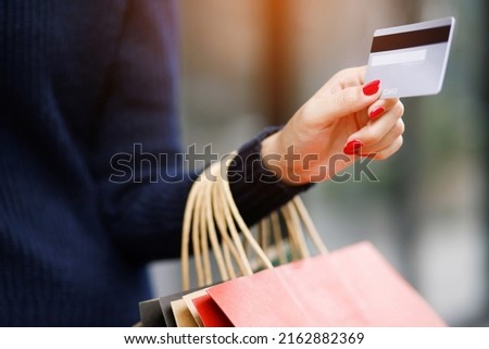 woman person holding a wallet in the hand of a  take credit card out of pocket. Cost control expenses shopping in concept. Leave space to write descriptive text.
