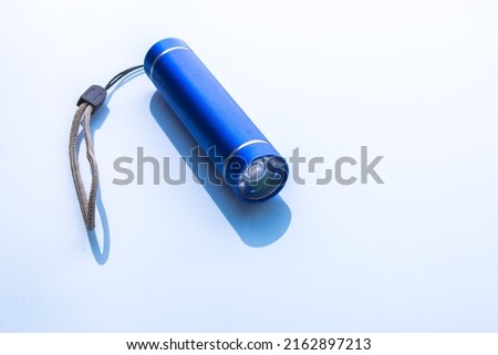 Blue pocket flashlight on white background