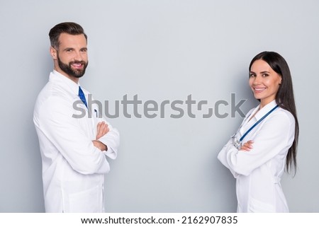 Profile side view portrait of two attractive cheerful medics folded arms team therapy copy space isolated on grey color pastel background Royalty-Free Stock Photo #2162907835