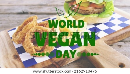 Image of world vegan day text over fresh hamburger. world vegan day and celebration concept digitally generated image.