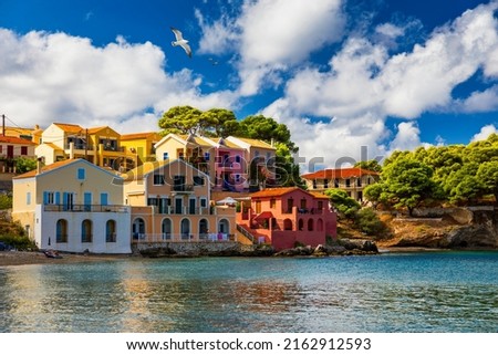 Assos village in Kefalonia, Greece. Turquoise colored bay in Mediterranean sea with beautiful colorful houses in Assos village in Kefalonia, Greece, Ionian island, Cephalonia, Assos village. Royalty-Free Stock Photo #2162912593