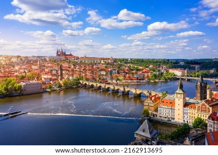 Scenic view of the Old Town pier architecture and Charles Bridge over Vltava river in Prague, Czech Republic. Prague iconic Charles Bridge (Karluv Most) and Old Town Bridge Tower at sunset, Czechia. Royalty-Free Stock Photo #2162913695
