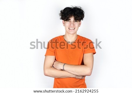 The teenage boy smiles and happy on a light background, he has successfully finished school and is now studying in college to be an artist and very happy about it. Portrait of a cheerful teenager