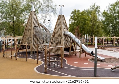 Children's playground in the form of a pyramid, an original children's playground, wooden attractions for kids, a modern city recreation park. High quality photo