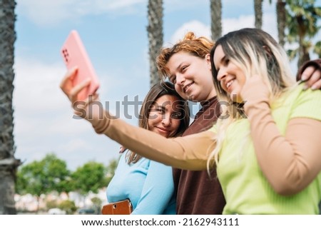 Group of college students taking a photo on campus