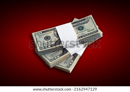 Bundle of US dollar bills on crimson red background. Pack of american money with high resolution on dark red background with dark vignette