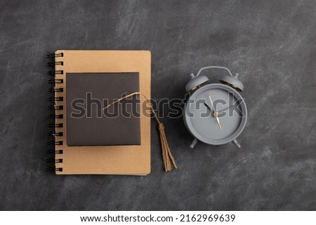 Back To School and education Concept. Alarm clock and over supplies on blackboard background. Copy Space, top view flat lay