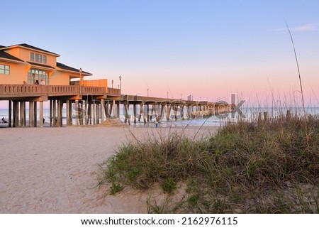 Beautiful  sunset over Jennette's Pier , Nags Head North Carolina. Originally built in 1939, Jennette’s is the oldest fishing pier on the Outer Banks, NC USA Royalty-Free Stock Photo #2162976115