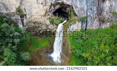 waterfall coming out of a cave and falling down the mountain, in santander colombia