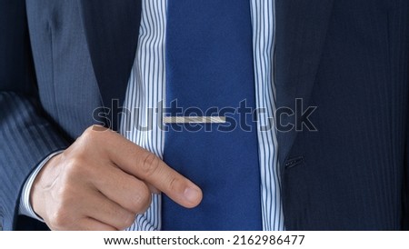 A businessman who wears a tie clip. Royalty-Free Stock Photo #2162986477
