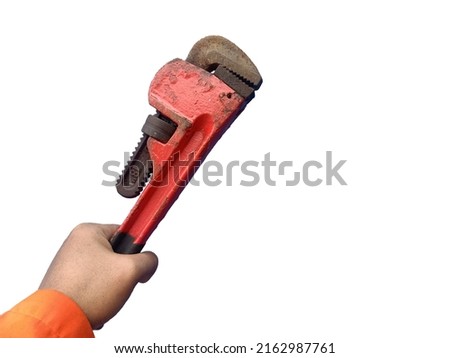 Stock image of man holding rusty red pipe wrench or monkey wrench isolated on white background