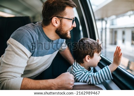 Father and son travel together by fast train and taking selfie photo. Royalty-Free Stock Photo #2162989467