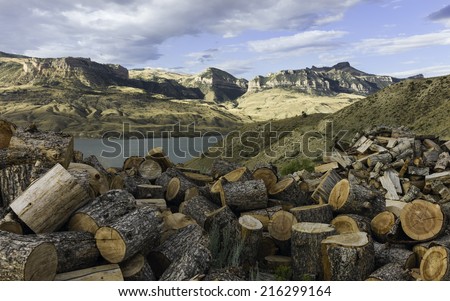 Cody, Wyoming, USA - Buffalo Bill State Park showing the mountains in the background, the Shoshone River, and logs of firewood in the foreground pictured near Cody, Wyoming, USA. 