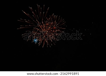 Very beautiful fireworks against the black sky with copy space for text or inscriptions. A graphic resource for design. Blank for the designer. Underlay or undercoat.