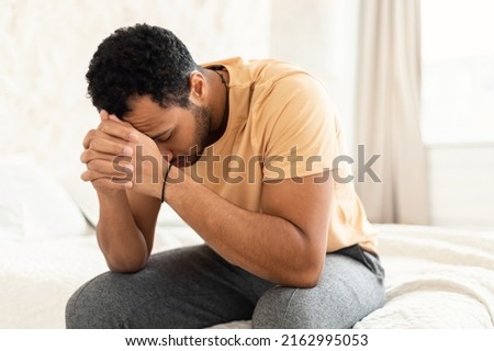 Male Depression. Unhappy Middle Eastern Guy Covering Face Having Stress And Problems Sitting In Bedroom At Home. Unrecognizable Man Suffering From Depressing Thoughts. Mental Health Concept Royalty-Free Stock Photo #2162995053