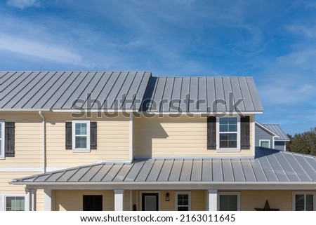 Single family home featuring a metal roof. Royalty-Free Stock Photo #2163011645