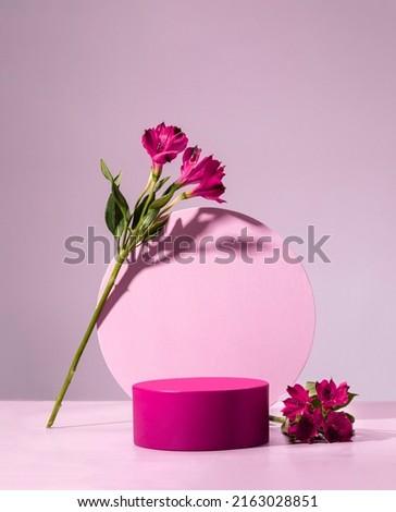 purple cylindrical podium, Cosmetic display stand with flowers on pink background
