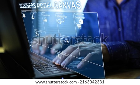 Businessman planning a business plan with business model canvas through laptop to project presentation and budgeting from high net worth investors value proposition cost and revenue business strategy. Royalty-Free Stock Photo #2163042331