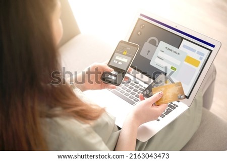Young woman with credit cards using modern smartphone and laptop for online payment
