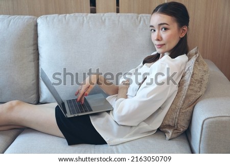 Portrait picture of Young Caucasian woman smile relax before sleep on sofa bed