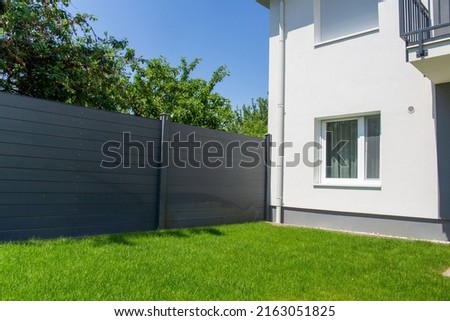 Modern privacy fence as garden or property boundary Royalty-Free Stock Photo #2163051825