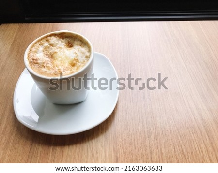 Picture of a hot coffee mug placed in a coffee shop, coffee time on a relaxing day