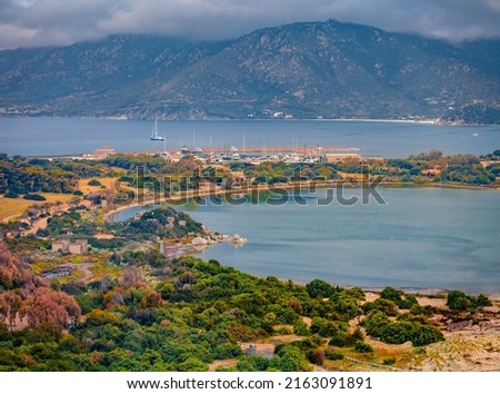 Gloomy summer view of Villasimius port. Aerial morning scene of Sardinia island, Italy, Europe. Spectacular seascape of Mediterranean sea. Traveling concept background.