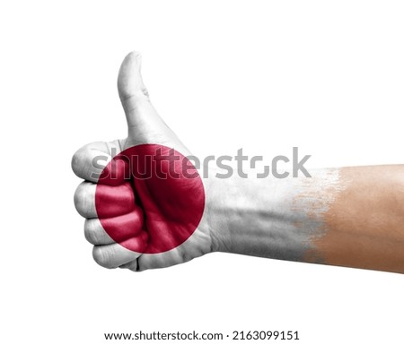 Hand making thumb up painted with flag of japan