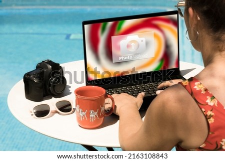 woman Travel photography downloading images on the laptop to upload to the cloud. Travel photographer creating photographic content for networks working .  woman Travel photography concept