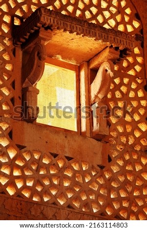 Royalty free photo of a Carved Stone window (Jharoka) in a tomb of muslim ruler of Sindh Miza Isa Khan Tarkhan II (1644 AD), at Makli necropolises. One of the largest necropolises in the world